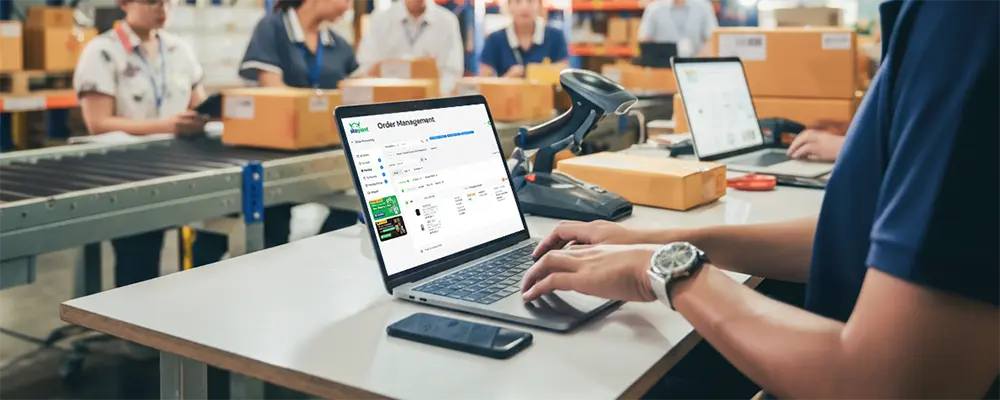 Ecommerce staff working on a laptop displaying the SiteGiant Order Management System to manage multichannel orders.